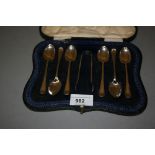 Cased set of six Sheffield silver bright cut coffee spoons with tongs