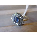 Art Deco style sapphire and diamond flower head ring, the central oval sapphire surrounded by ten