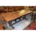 Early 20th Century oak refectory style dining table with a plank top on carved melon bulb supports