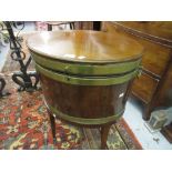 George III oval mahogany and brass banded wine cooler raised on square tapering supports with