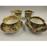 Two early 19th Century Coalport trios painted with roses within blue and gilt borders Some minor