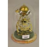 Thwaites & Reed, small 8in gilt brass skeleton clock under glass dome, with onyx base