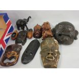 Box containing a quantity of various wall masks, oriental carved figure of a sage and a carved ebony