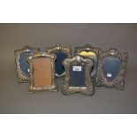 Pair of modern silver mounted photograph frames with heart shaped apertures together with four other