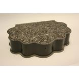 19th Century colonial carved ebony box, the shaped hinged cover heavily carved with flowers (