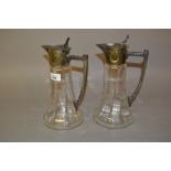 Pair of Continental glass and silvered pewter mounted claret jugs of Art Deco design