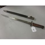Bayonet with scabbard, the 16.75in blade inscribed 1907 Wilkinson
