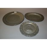 Pair of antique circular pewter platters, two similar smaller oval platters and a pair of antique
