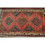 Hamadan rug, triple medallion design on a rose ground with multiple borders and another machine made