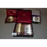 Cased set of twelve Continental silver spoons, similar Continental silver cased set of eleven spoons