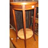 Edwardian mahogany circular two tier jardiniere stand, a wrought iron three tier cake stand with