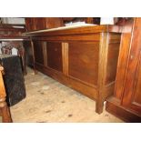 Large reproduction oak coffer with a hinged plank lid above a three panel front