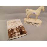 White Horse Scotch whisky advertising figure, together with one volume ' Shackleton's Whisky ' by