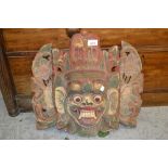 Far Eastern carved wooden polychrome wall mask