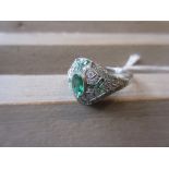 Platinum emerald and diamond set dress ring
