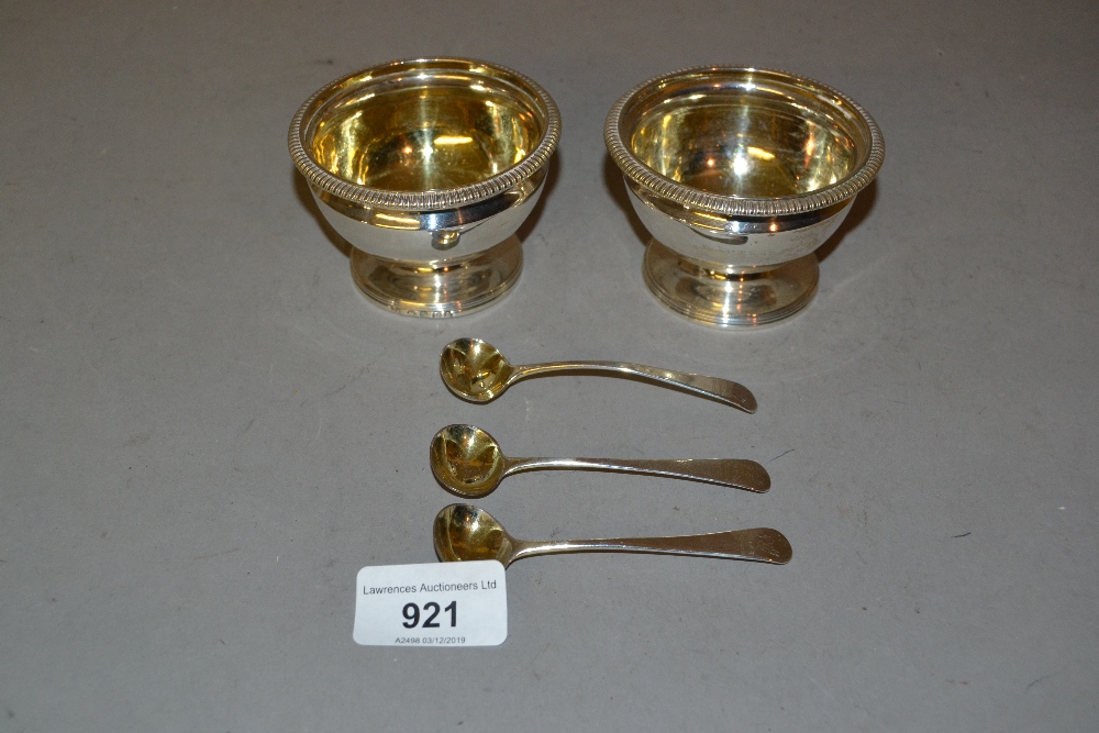 Pair of George III silver circular salts with gilded interiors together with a pair of spoons