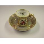 18th Century Sevres porcelain cabinet cup and saucer painted with panels of roses within blue and