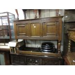 Heals 20th Century oak sideboard, the moulded top above two panel doors, raised on turned supports