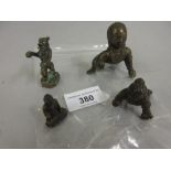 Two Asian cast bronze crawling figures, a miniature bronze figure of a seated Buddha and a German