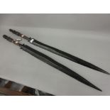 Two African native carved hardwood ceremonial swords