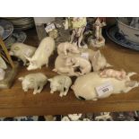 Three Belleek porcelain figures of pigs, two Beswick figures of pigs and a Lladro pig group All in