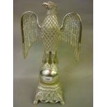 Cast aluminium figure of an eagle perched on a globe with polished finish, 18ins high
