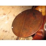 Antique circular oak pedestal table with a turned column and tripod support