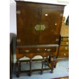 Burr walnut side cabinet on stand in 18th Century style, the moulded top above two flush panel doors