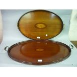 Two Edwardian mahogany oval two handled trays having central inlaid decoration and brass handles