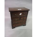 19th Century miniature mahogany and inlaid chest with a fitted secretaire drawer above two short and