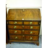 19th Century elm and oak bureau, the fall front enclosing a fitted oak interior above two short