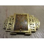 Art Deco style gilt brass, pierced and engraved brooch mounted with a rectangular painted plaque