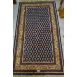 Persian style rug of all-over Boteh design with multiple borders on blue ground with signature to
