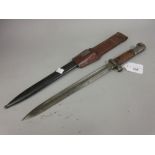 German bayonet with scabbard and leather frog with an 11.5in blade, the scabbard inscribed T.G.F.595