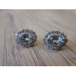 Pair of oval aquamarine and diamond cluster stud earrings