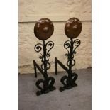 Pair of good quality Arts and Crafts wrought iron and copper fire dogs with circular copper flower