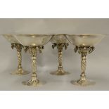 Georg Jensen set of four silver tazzas, the circular beaten bowls above baluster grapevine motif