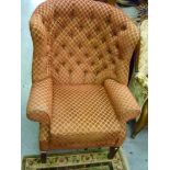 Reproduction button upholstered wing armchair in 18th Century style on square cut moulded supports