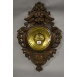 19th Century French carved oak aneroid barometer, the pierced floral cartouche case with inset brass
