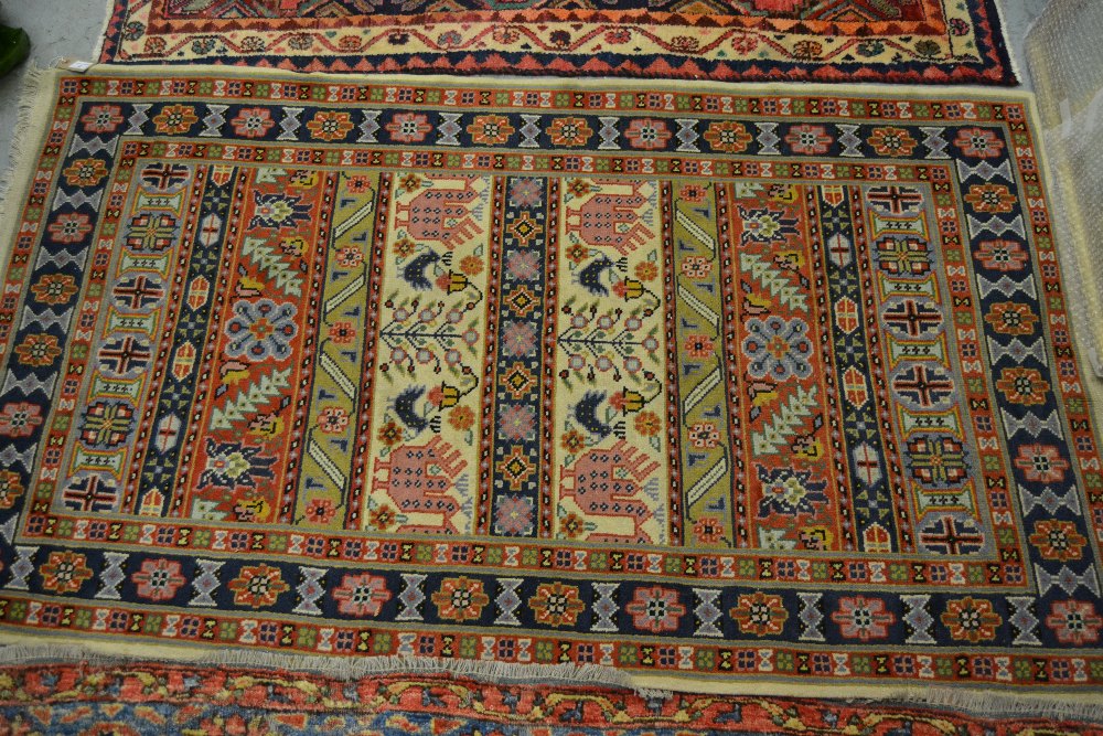 Indo Persian rug with a banded design in pastel shades, together with a small Belouch rug