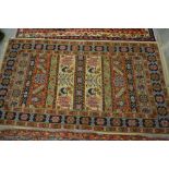 Indo Persian rug with a banded design in pastel shades, together with a small Belouch rug