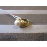 Yellow metal pearl set ring