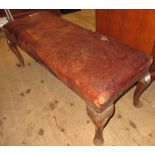 Long 20th Century rectangular leather upholstered footstool on oak cabriole pad supports (cover at