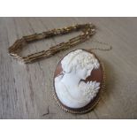 9ct Gold mounted cameo brooch and a 9ct gold gate link bracelet (safety chain at fault)