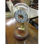 Bulle electric mantel clock, the painted dial with Arabic numerals and visible escapement on a brass