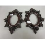 Pair of late 19th Century oval mahogany frames, carved with acorns, flowers and leaves