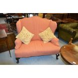 1920's Antique style wing back two seat sofa having pink and cream loose cover raised on cabriole