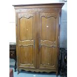 19th Century French cherry wood armoire, the moulded cornice above two floral carved panel doors