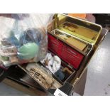 Box containing a quantity of various bone sewing needles, bobbins and sewing related items