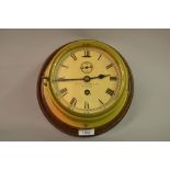 Early 20th Century ships brass bulkhead clock with painted dial, having Roman numerals, subsidiary